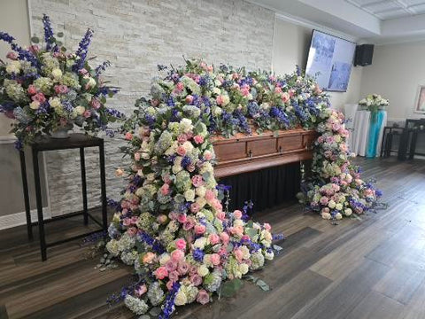 # 269 Full Cascading Casket Floral Installation in Pink, Blue & White – Luxury Tribute by Marchello’s Floral