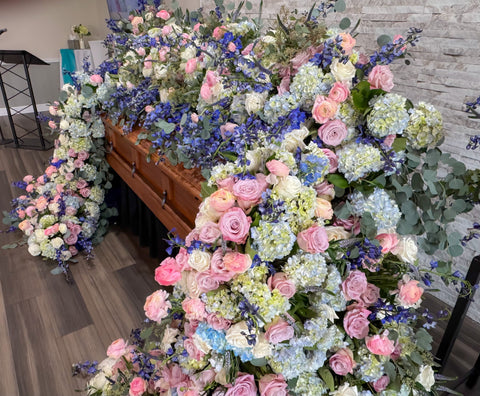 # 269 Full Cascading Casket Floral Installation in Pink, Blue & White – Luxury Tribute by Marchello’s Floral