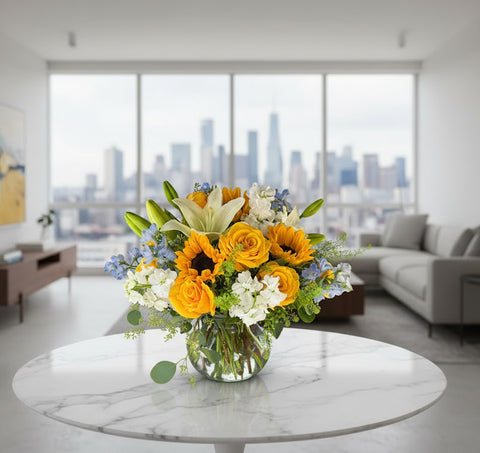 Golden Glow Summer Floral Centerpiece – Sunflowers, Yellow Roses & White Lilies in Glass Vase